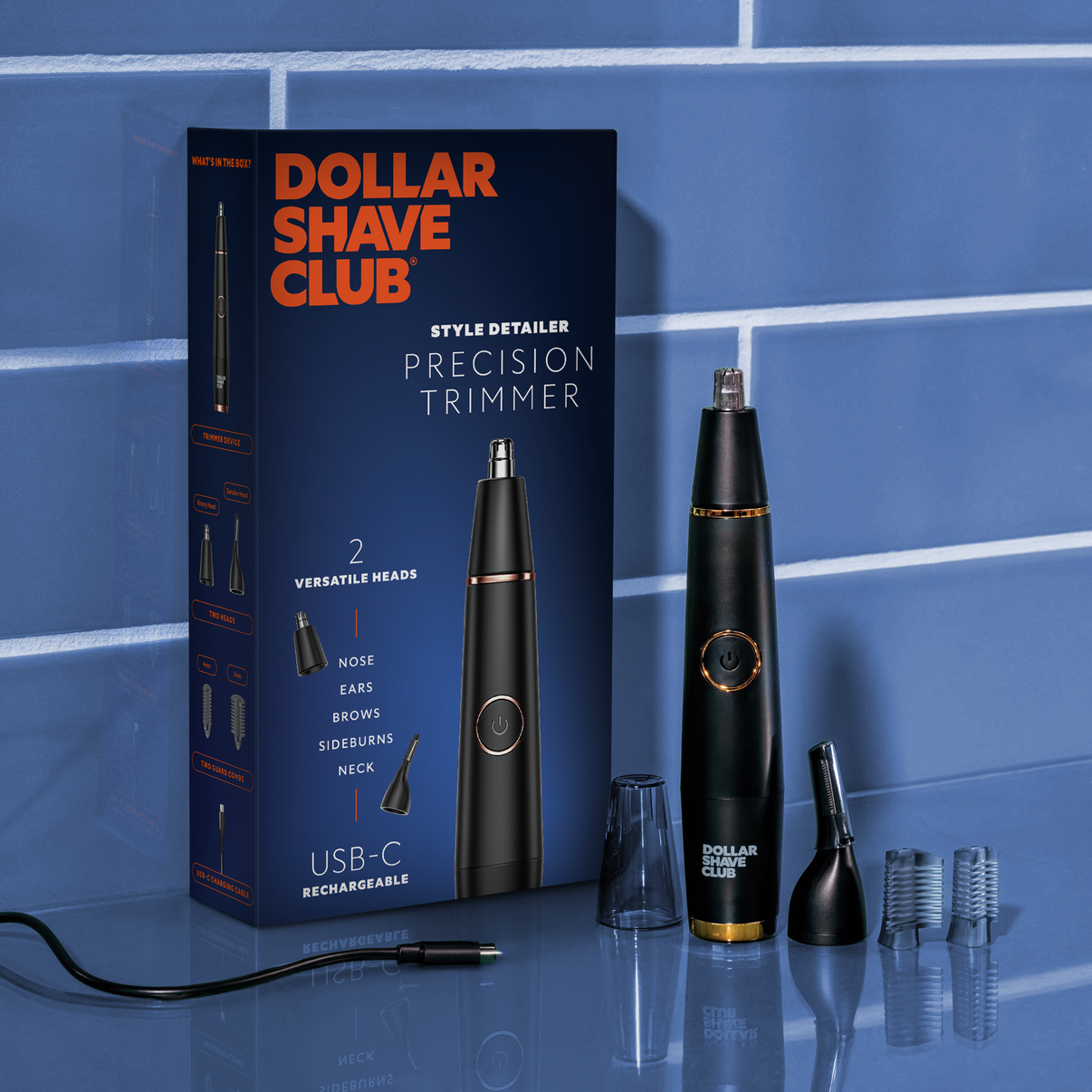 Style Detailer and attachments shown next to box on blue bathroom counter.