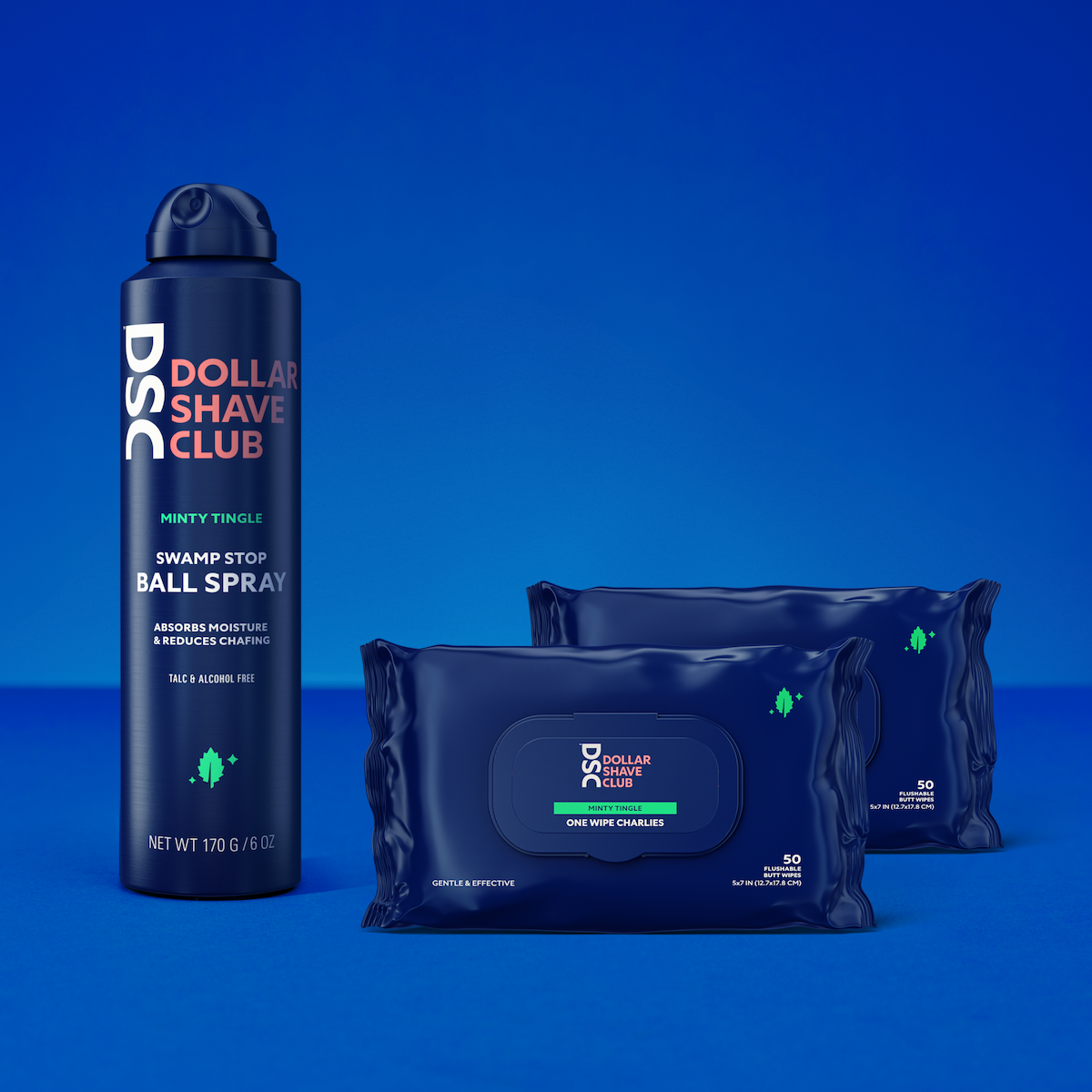 Dollar Shave Club Ball Spray and One Wipe Charlies Set Against Blue Background.