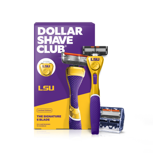 Dollar Shave Club Louisiana State University grooming kit on a white background. Includes a purple razor handle with the LSU Tigers logo, 24 blades, Shave Butter, Prep Scrub, a black 3-in-1 electric trimmer, and a black traveler case.