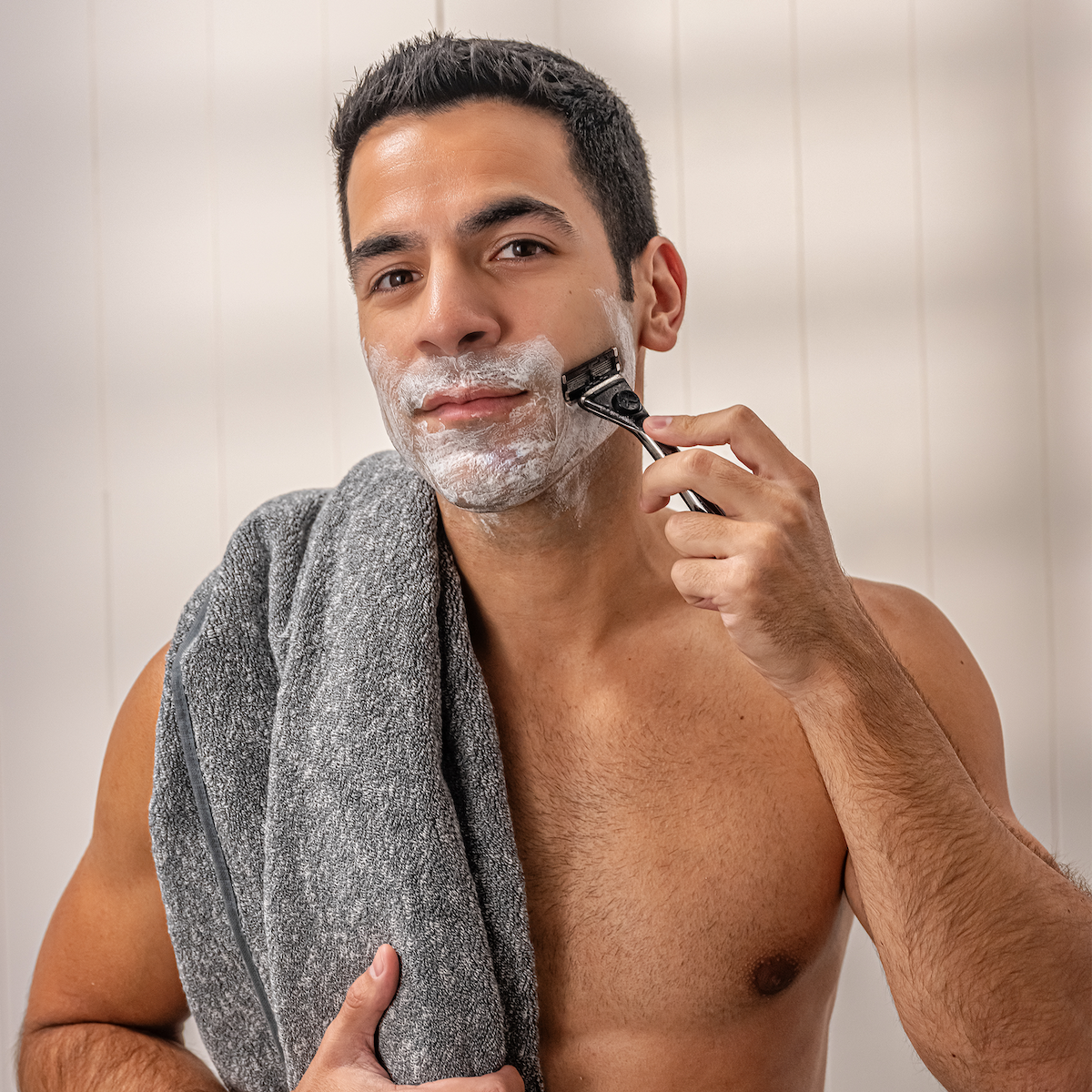 Man shaving with Dollar Shave Club Heavy Metal Handle and Club Series 6 Blade Razor.