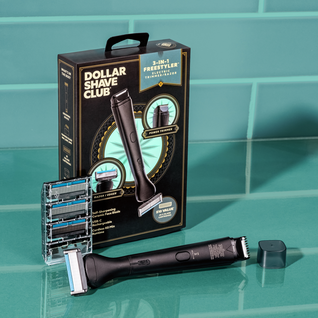 A photo of the 3-in-1 Freestyles with trimmer cap, 4 ct cassette of Club Series 6 Blade Razors, and the packaging box on a teal green counter with teal green tile in the background