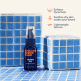 Dollar Shave Club beard oil bottle on a tiled surface with product benefits text.