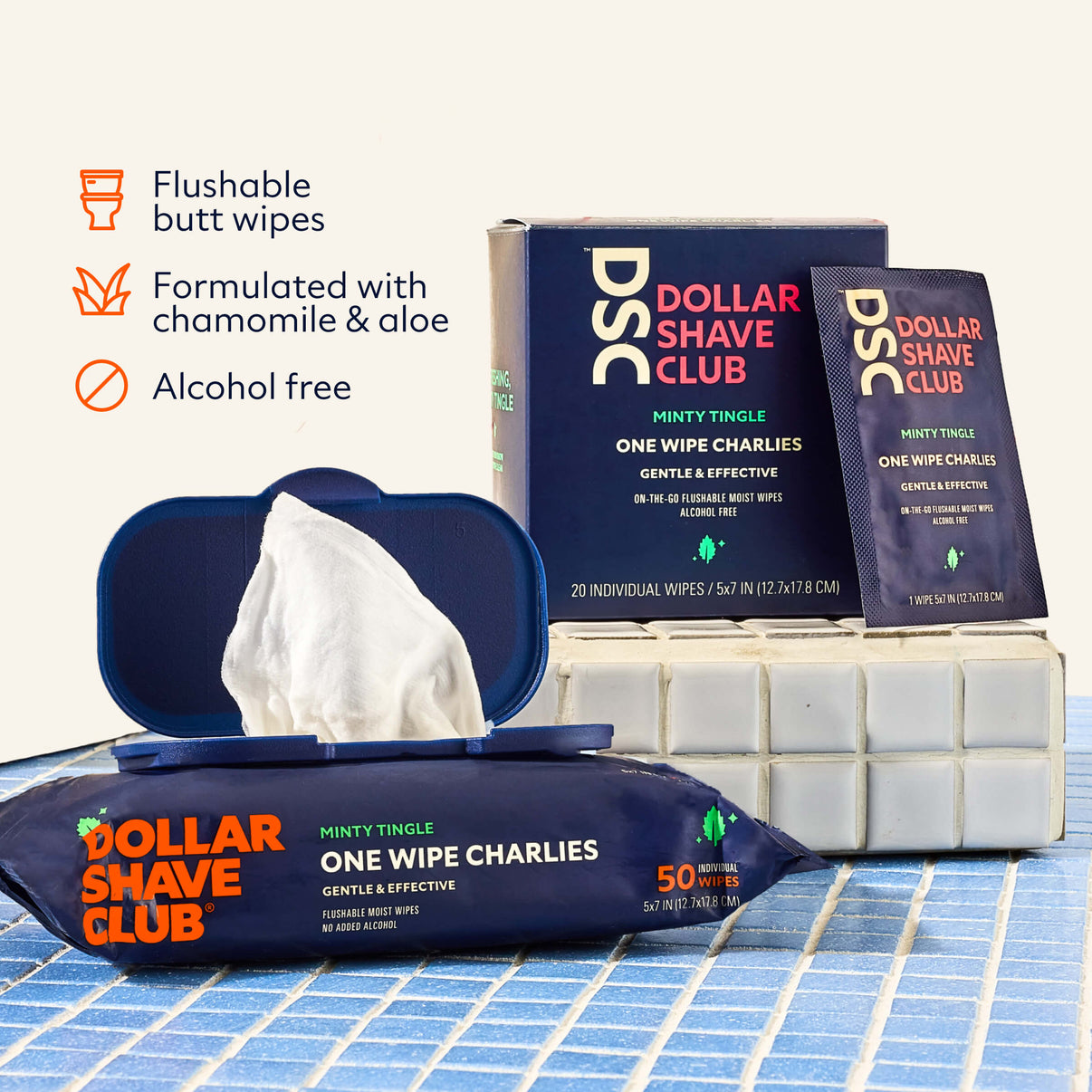Dollar Shave Club flushable butt wipes packaging on a tiled floor.