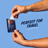Hand holding a Dollar Shave Club product with text 'Perfect for Travel' on a blue background
