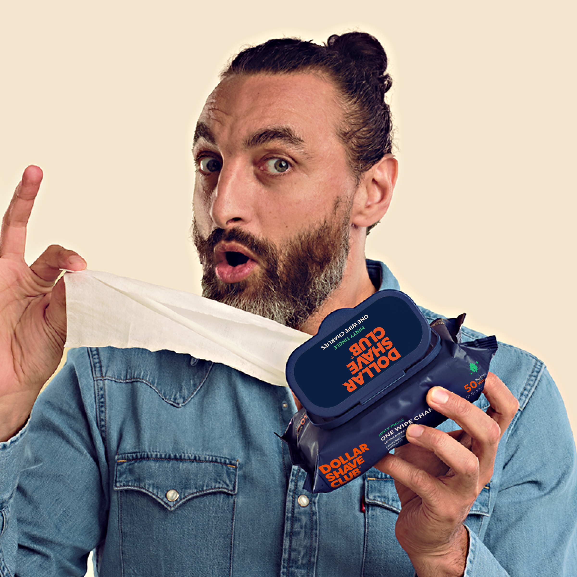 Man with beard pulling out a wipe from the One Wipe Charlie package.