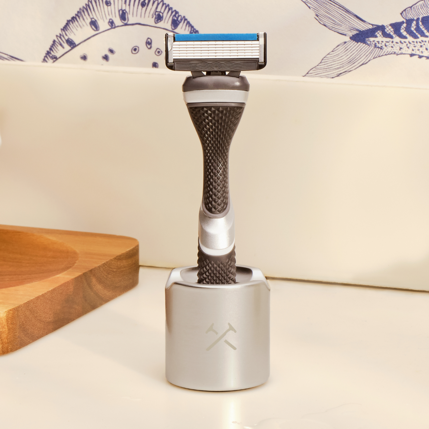 razor blade and handle shown standing upright in silver razor stand.