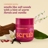 Dollar Shave Club scrub jar with floral and wood elements on a beige background