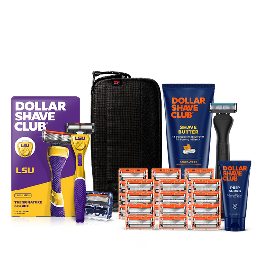 Dollar Shave Club Louisiana State University grooming kit on a white background. Includes a purple razor handle with the LSU Tigers logo, 24 blades, Shave Butter, Prep Scrub, a black 3-in-1 electric trimmer, and a black traveler case.