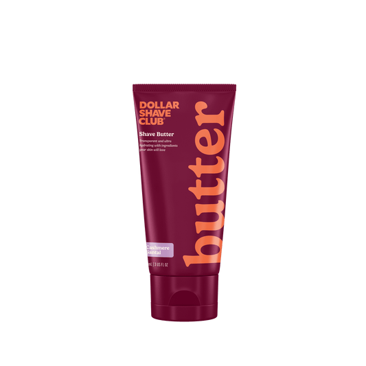 Dollar Shave Club shave butter tube with maroon and orange design on a white background