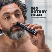 A photo of a bearded man using the Style Detailer to trim him nose hairs
