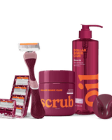 Dollar Shave Club grooming products including a razor, scrub, and shave oil on a black background.