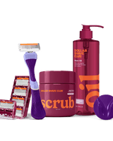Dollar Shave Club grooming products including a razor, scrub, and shave oil on a black background.