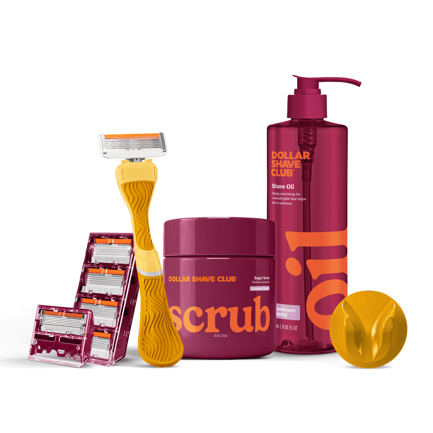 Dollar Shave Club grooming products including a razor, scrub, and shave oil on a black background.