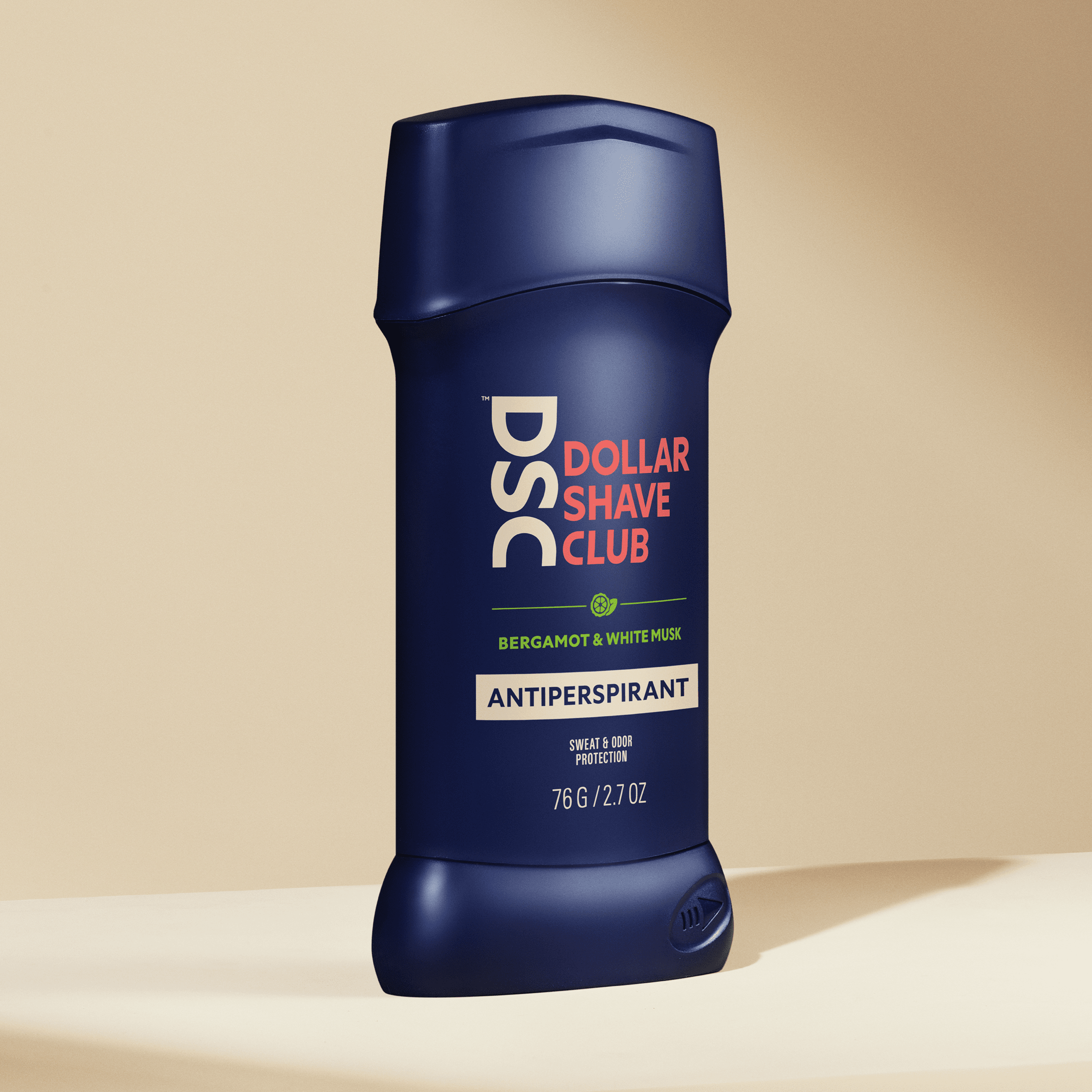 Dollar Shave Club Antiperspirant Sea Spray Amber against tan backdrop.