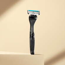 Dollar Shave Club Club Series Four blade razor product image with tan backdrop.