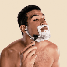 Man shaving with Dollar Shave Club Club Series Four blade razor.