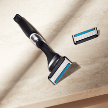 Dollar Shave Club Club Series Six blade razor product image with tan backdrop.