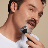 Man shaving with Dollar Shave Club Club Series Six blade razor.