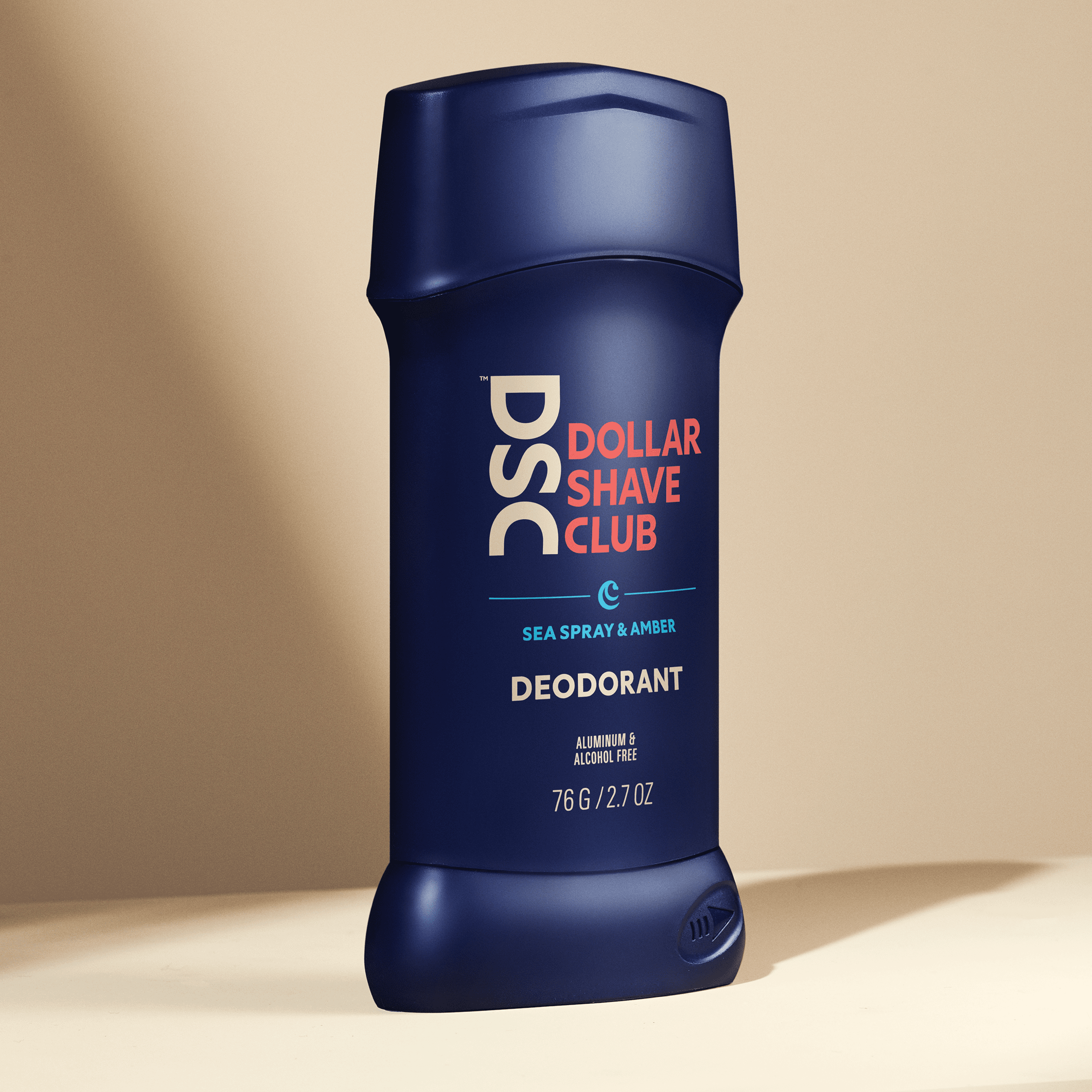 Dollar Shave Club Deodorant Sea Spray Amber against tan backdrop.
