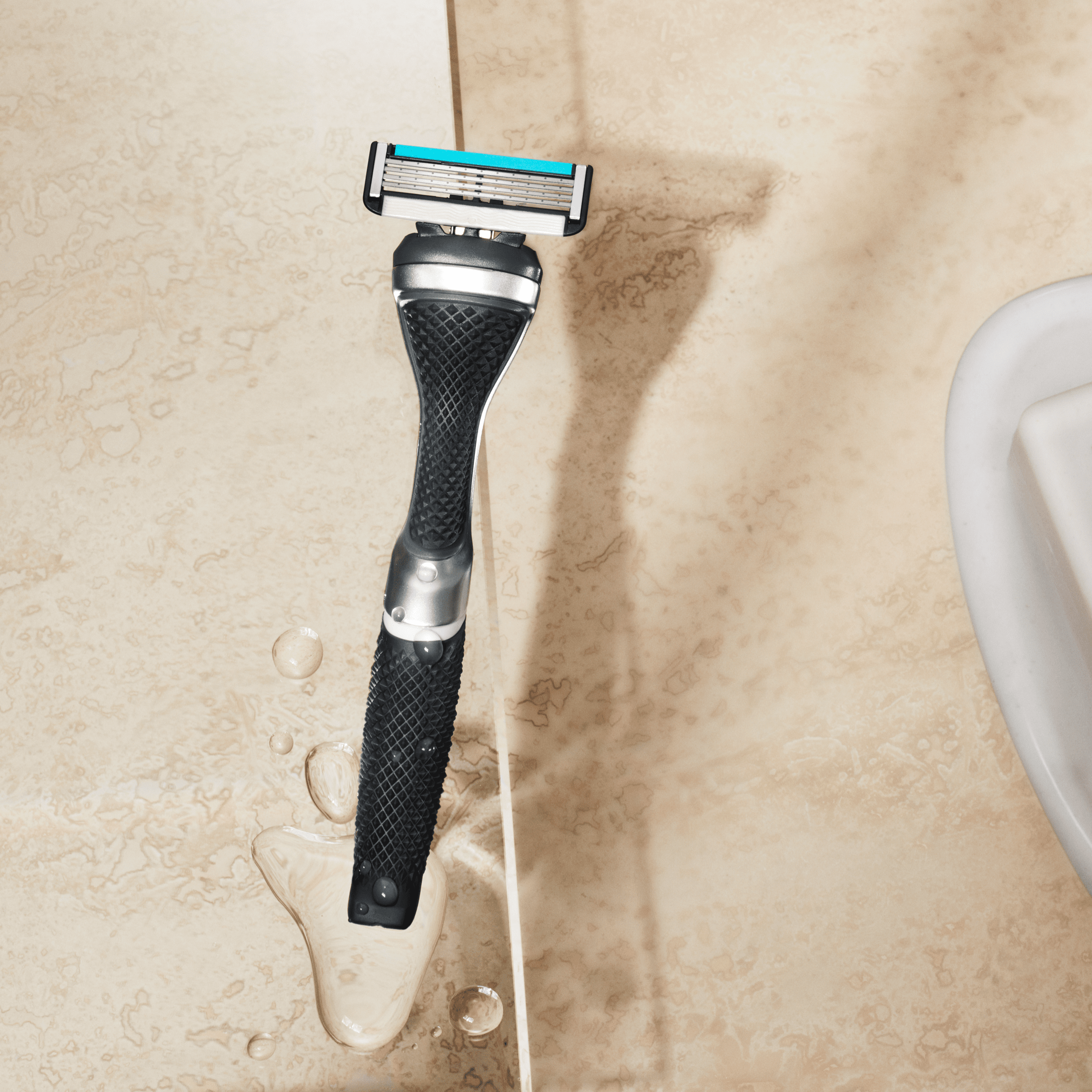 Dollar Shave Club Diamond Grip Handle Silver product image with tan backdrop.