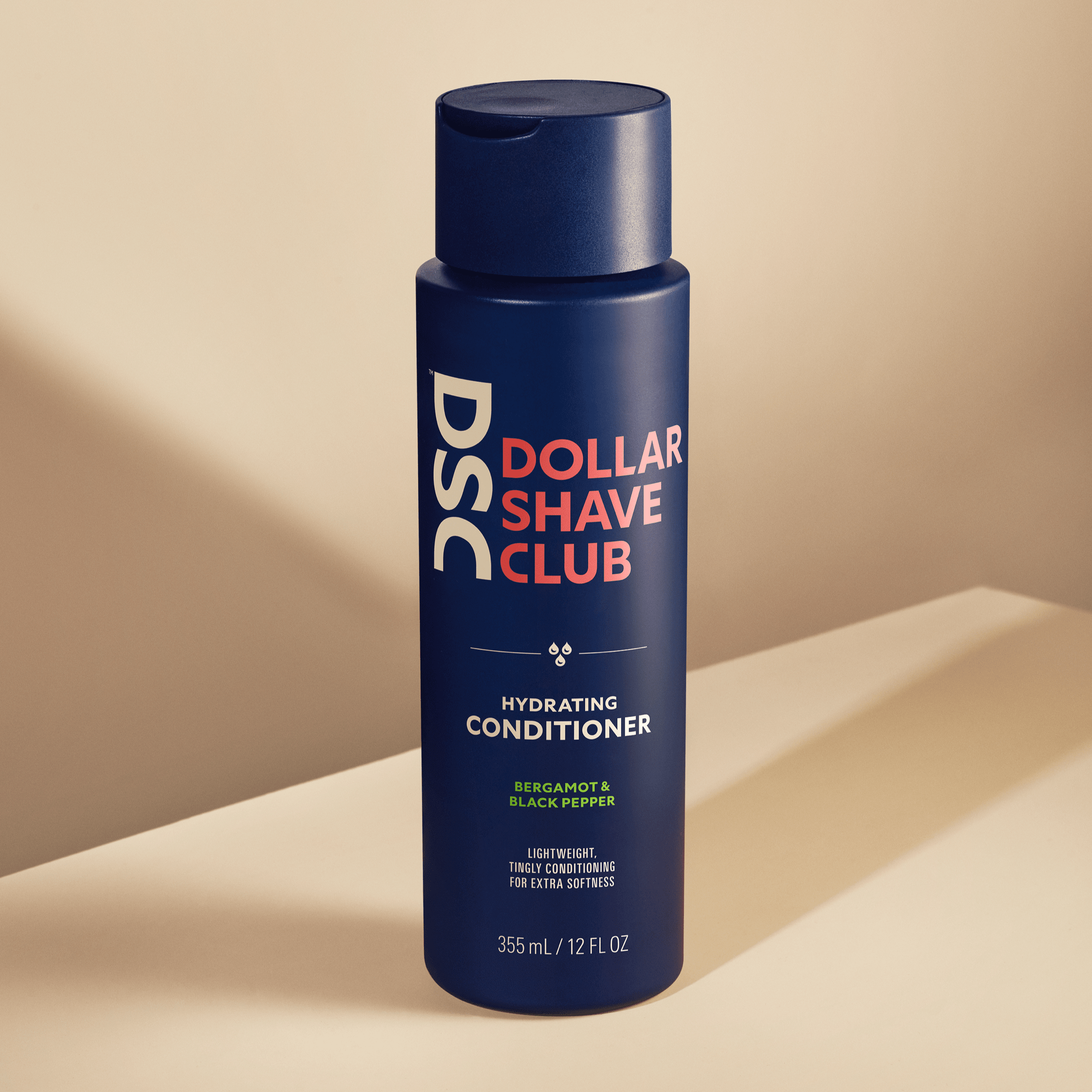 Dollar Shave Club Hair and Scalp Conditioner against tan backdrop.