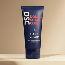Dollar Shave Club Hand Cream against tan backdrop.