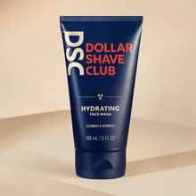 Dollar Shave Club Hydrating Face Wash against tan backdrop.