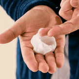 Dollar Shave Club Shave Butter product in a man's hand.