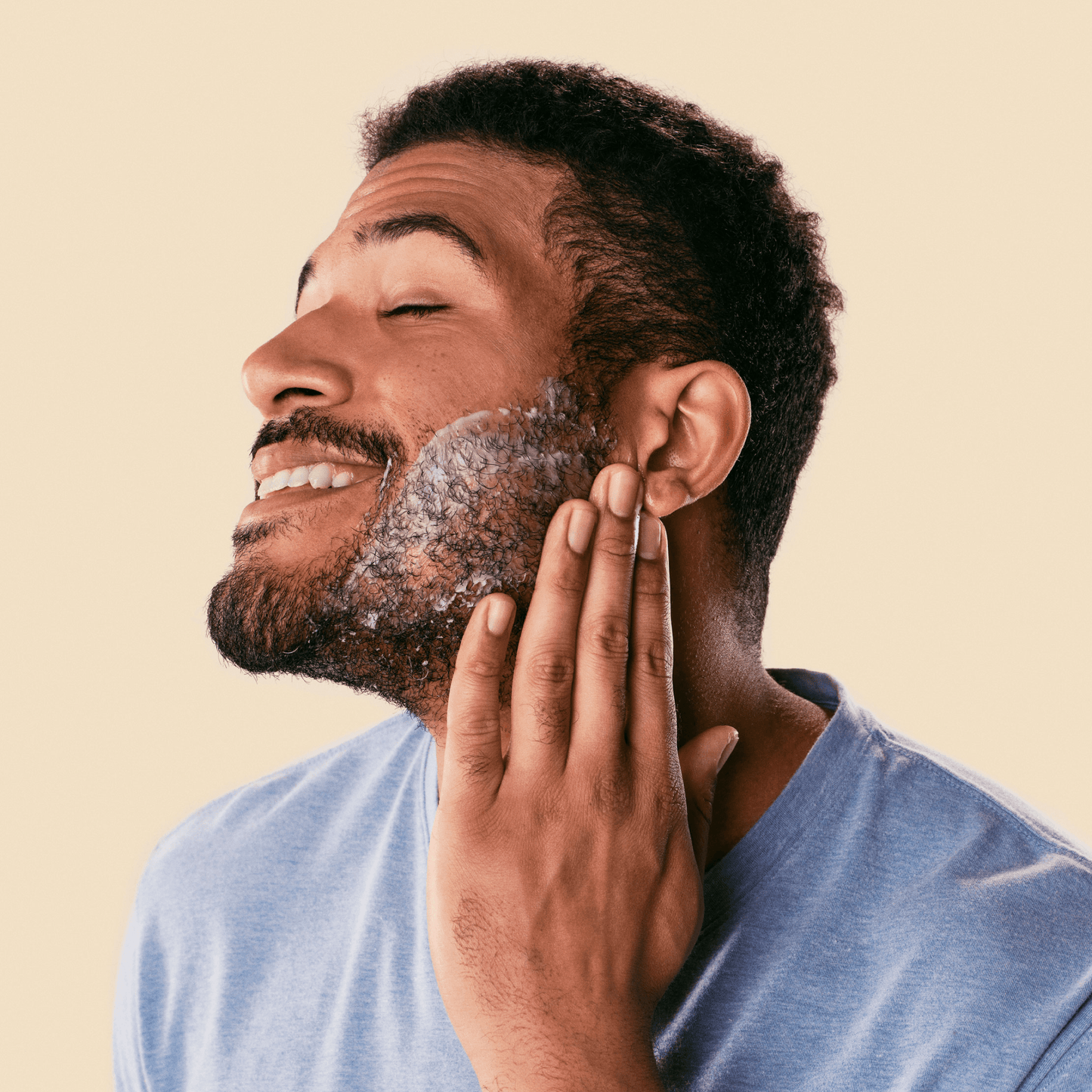 Man applying Dollar Shave Club Shave Butter to his face.