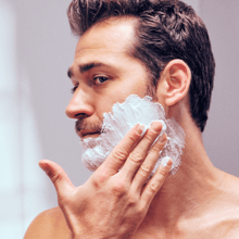 Man applying Dollar Shave Club Shave Gel to his face.