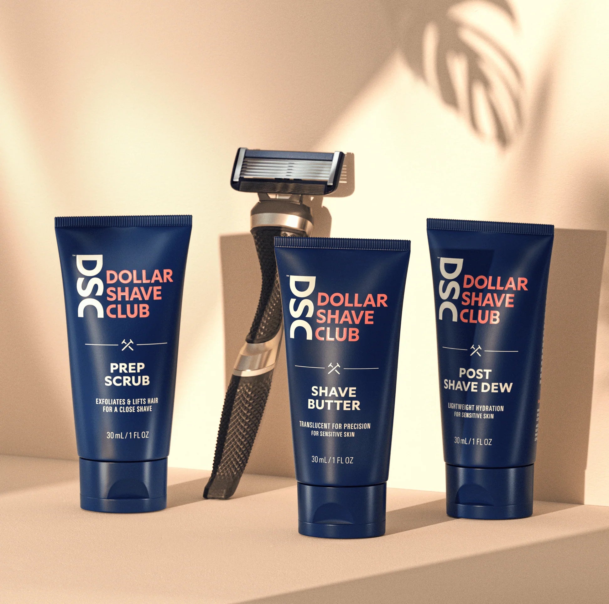 Dollar Shave Club Ultimate Shave Trial Kit Image Featuring All Products on Tan Backdrop. 