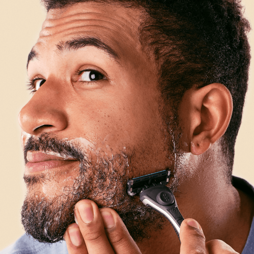 man shaving beard